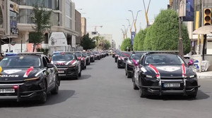 Iraqi security forces parade in streets, marking withdrawal of US-led coalition