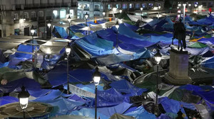 Spain's housing protesters remain camped in Madrid square despite snap election call