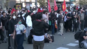 Riot police run at student protesters during street clashes