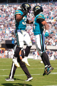 Jacksonville Jaguars running back Bhayshul Tuten (33) congratulates Jacksonville Jaguars running back Chris Rodriguez Jr. (24)