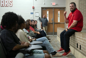 West Florida High School Offensive Line Coach David Gardner holds back tears on Oct. 27, 2026, as he speaks to supporters after