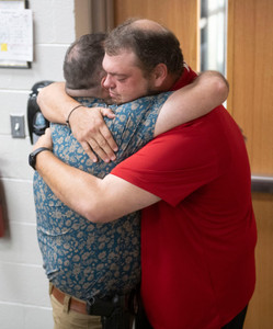 Friends, family, and co-workers congratulate West Florida High School Offensive Line Coach David Gardner after learning he was