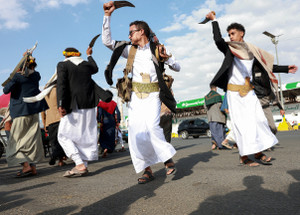 People perform the traditional Baraa dance at Sabeen Square in downtown Sanaa