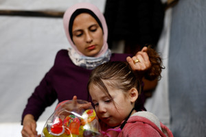 The Wider Image: Evacuated in an incubator, now back in Gaza getting to know mama