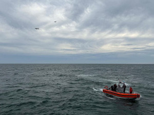 US Coast Guard members search for people after it found debris from a medical transport aircraft off the shore of Massachusetts' Nantucket island