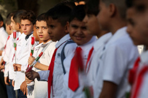 Iraqi school students attend the first day of the academic year at a primary school