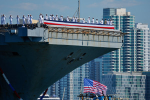 The US Navy Nimitz-class aircraft carrier USS Abraham Lincoln returns home following an extended deployment in the Middle East at Naval Base Coronado in San Diego