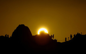 Several tourists watch the sunset in Teide National Park on the island of Tenerife