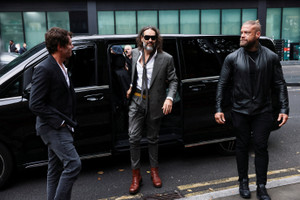 British actor and comedian Russell Brand arrives to stand trial on charges of rape and sexual assault, in London