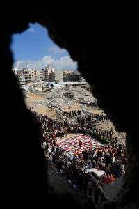 Mass funeral for Palestinians recovered from the rubble of a residential building hit in an Israeli strike in October 2023