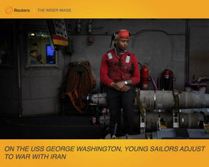 The Wider Image: On the USS George Washington, young sailors adjust to war with Iran