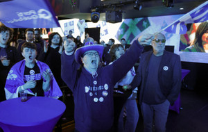 A supporter of Parti Quebecois (PQ) leader Paul St-Pierre Plamondon cheers as he watches provincial election results at his election night headquarters in Montreal
