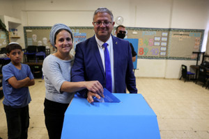 Israel's National Security Minister, Itamar Ben-Gvir, leader of the Jewish Power (Otzma Yehudit) party votes with his wife Ayala, on the day of Israel’s national election, in Kiryat Arba