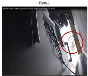 A handout photo shows what the US Justice Department says is Abdulrahman Alfozan, a Saudi national employed as an OpenAI engineer, checking a hidden audio recording device in an executive conference room at the AI company