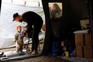 The Wider Image: Evacuated in an incubator, now back in Gaza getting to know mama