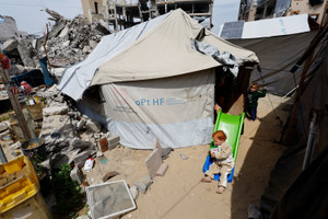 The Wider Image: Evacuated in an incubator, now back in Gaza getting to know mama
