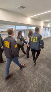 A California woman, Wanying Zhang is taken by the FBI after they arrested her, in Los Angeles
