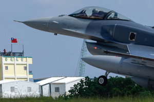 A Lockheed Martin F-16V fighter jet lands at Taitung's Chihhang Air Base in Taitung as people watch from a nearby hotel in Taitung