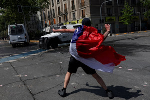 Demonstrators take part in a rally marking the seventh anniversary of the 2019 protests and riots, in Santiago